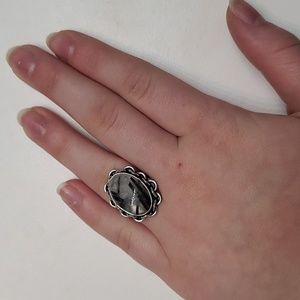 Grey and black stone set in engraved silver ring
